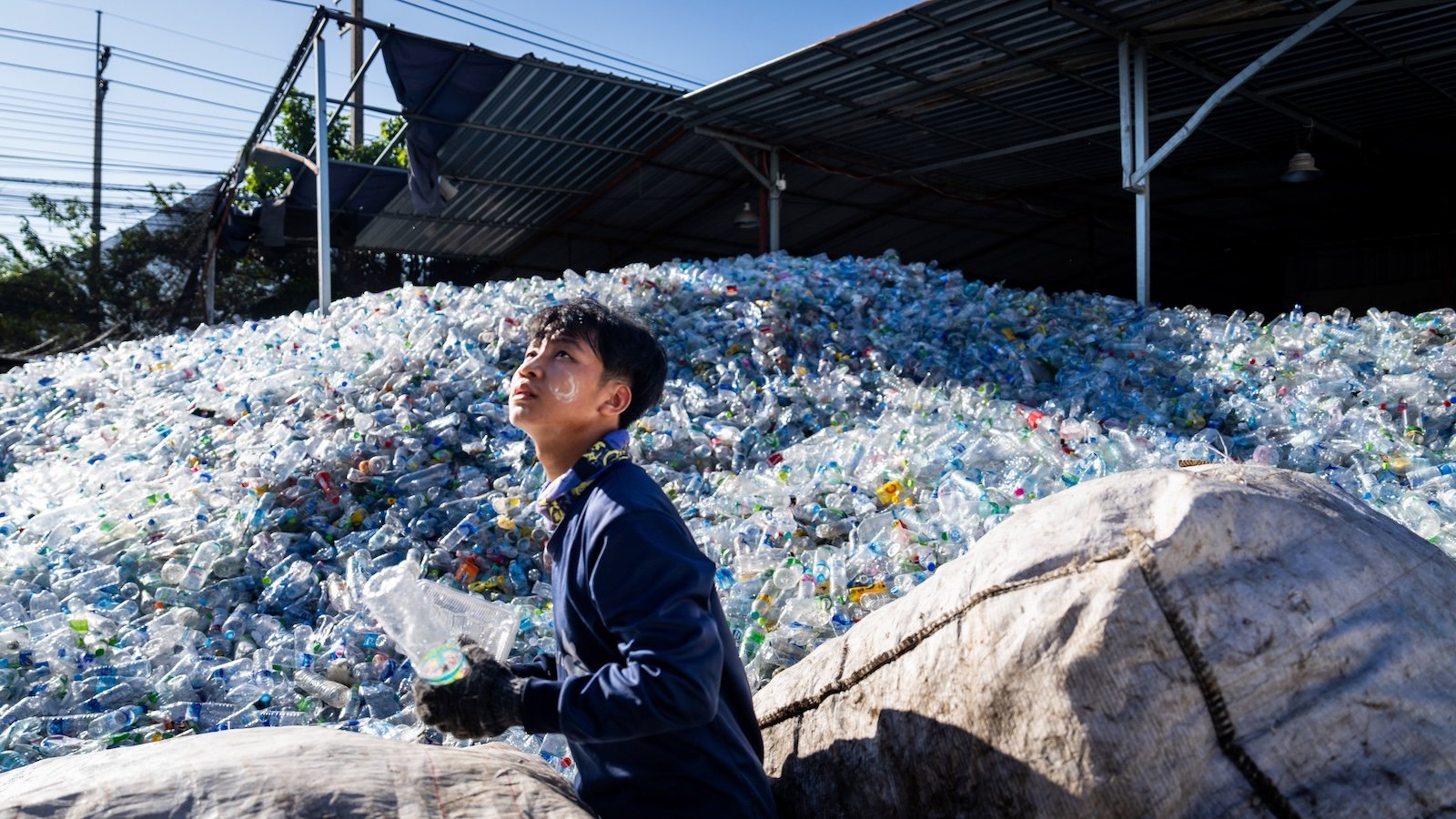 A worker sorts plastics at a sorting and compacting facility in Bang Phli in Samut Prakan, Thailand