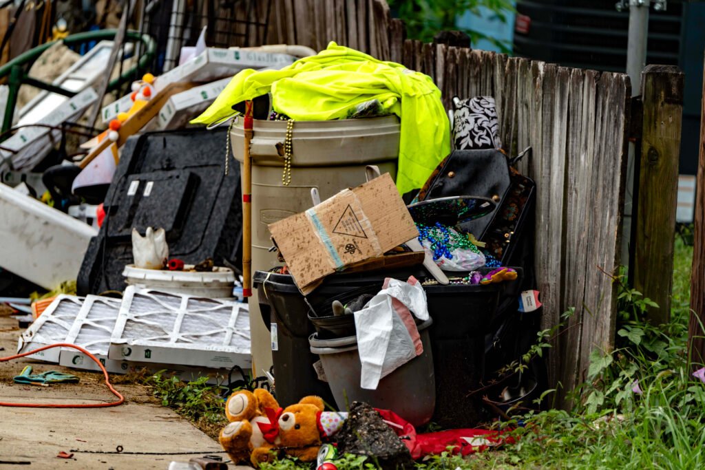 Waste and other materials are often stacked in side yards and near the street at homes with no trash can in Chickasaw, Alabama. Credit: Lee Hedgepeth/Inside Climate News