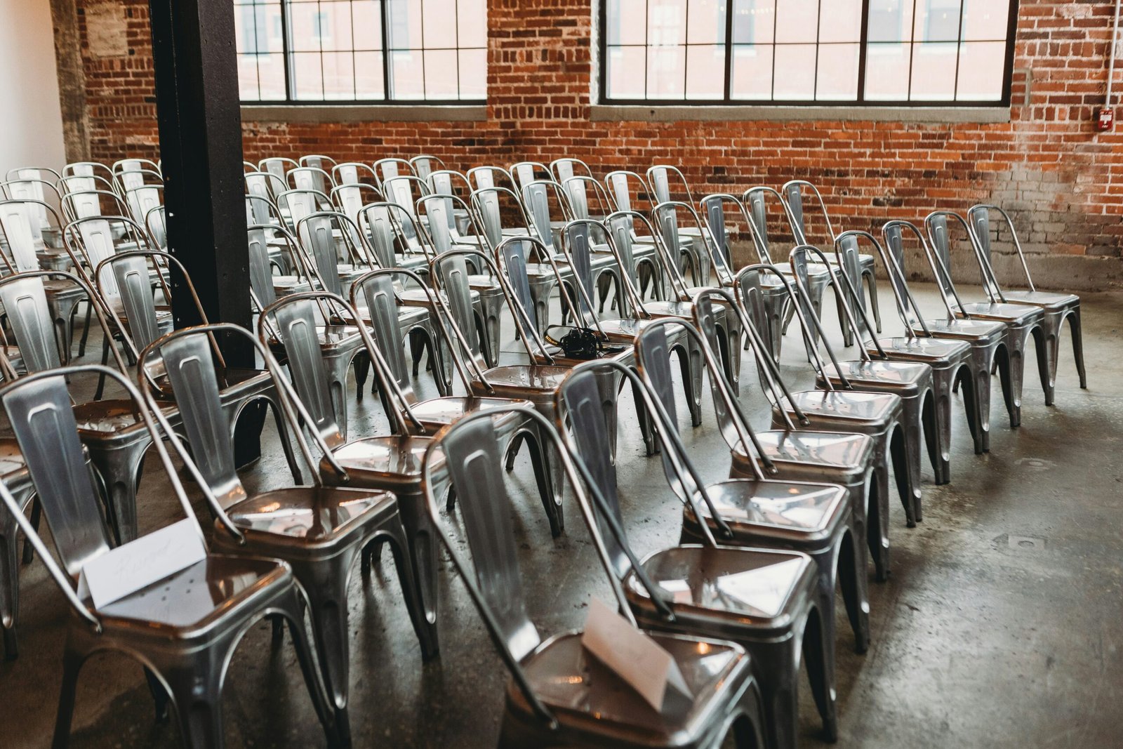 a room filled with lots of metal chairs