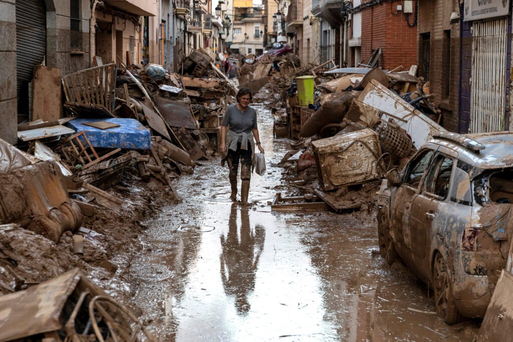 A woman walks along a flooded street on Nov. 2 in Valencia, Spain, after heavy rain hit large parts of the country. Scientists attributed the unprecedented flooding event to the rise in global average temperatures. Credit: Pablo Blazquez Dominguez/Getty Images